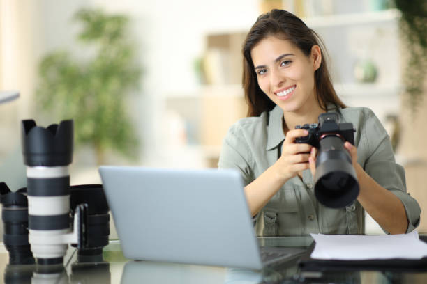 istock Happy photographer posing at home with equipment 1567067427