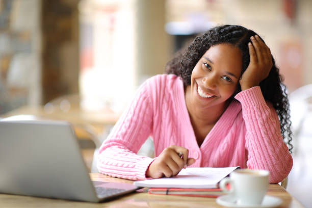 istock Happy black student looking at you in a bar 1567076583