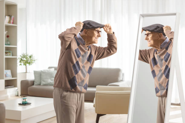 Elderly gentleman getting ready in front of a mirror