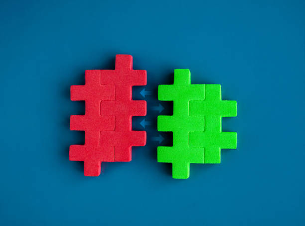 istock Red and green puzzle blocks between arrows are joining each other on blue background, minimal style. Business partnership, teamwork, collaboration, and contrast opposite colors concepts. 1567078222