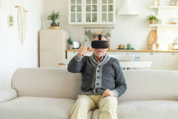 istock Excited mature senior man wearing using virtual reality metaverse VR glasses headset at home. Grandfather touching air during VR experience on virtual reality helmet. Simulation hi-tech videogame. 1567093963