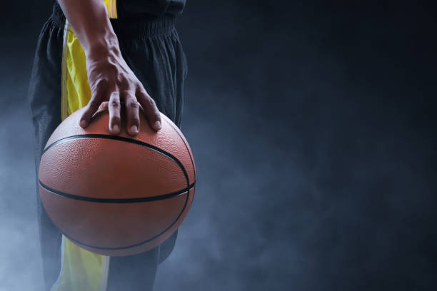 Basketball male player on dark background