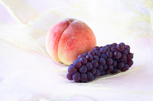 Peach and grapes on jute cloth