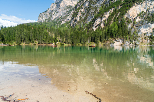 The lake is clear, sometimes green, sometimes blue, and surrounded by mountains. Nature's Wonderland: Lake Braies and its Captivating Alpine Scenery.