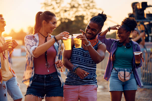 istock Cheerful festival goers having fun while toasting with beer. 1567116397