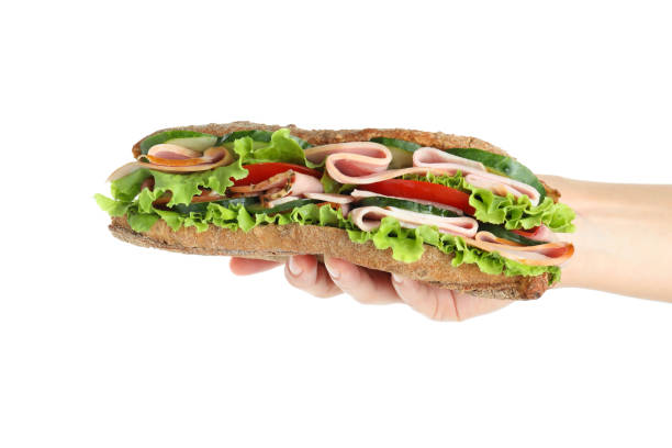istock Female hand holds ciabatta sandwich, isolated on white background 1567146828