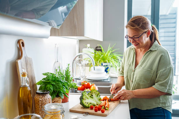 istock Woman chopping fresh vegetables 1567146864