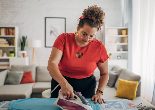 istock Woman ironing cloth in house 1567152930
