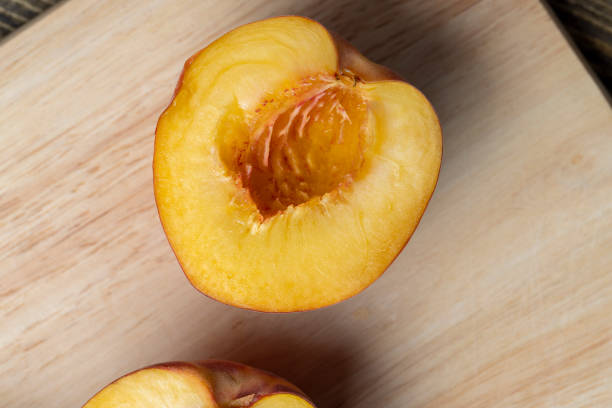 istock Ripe fresh peaches on a wooden table 1567155117