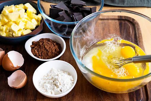 Ingredients of chocolate cake. Eggs, sugar, flour, chocolate and butter.