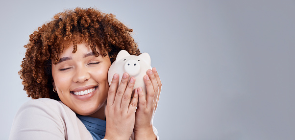 Happy woman with mockup, piggy bank and savings in studio, finance and budget in hands for investment plan. Happiness, growth and profit, salary management for girl with money box on white background