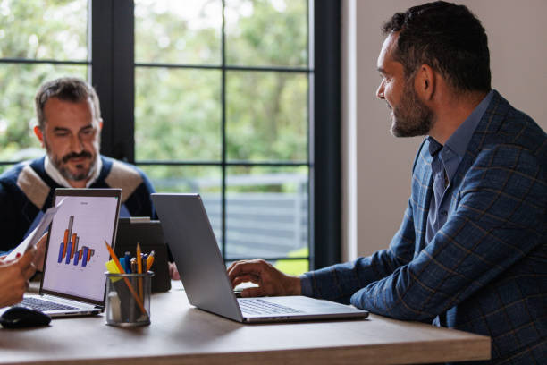 istock Two businessmen working together on a project 1567166750