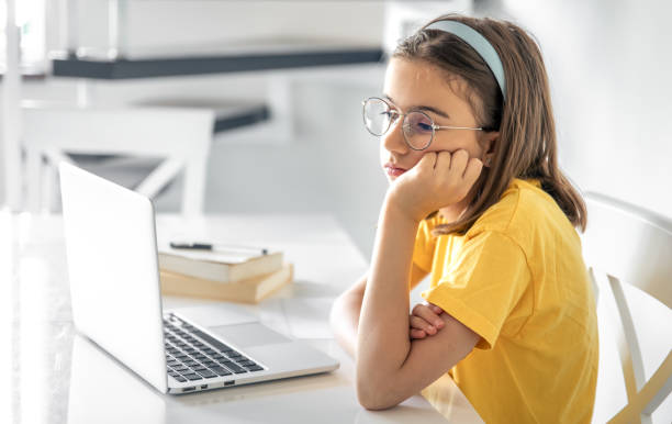 istock Exhausted schooler girl suffering from doing homework, tired from studying. 1567166782