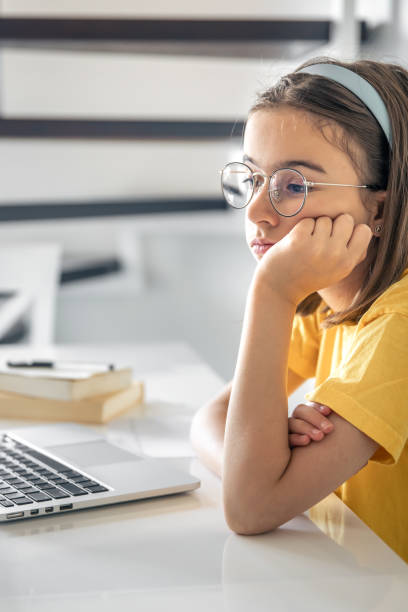 istock Exhausted schooler girl suffering from doing homework, tired from studying. 1567166950
