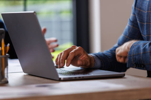 istock Businessman typing data on laptop at his desk 1567167341