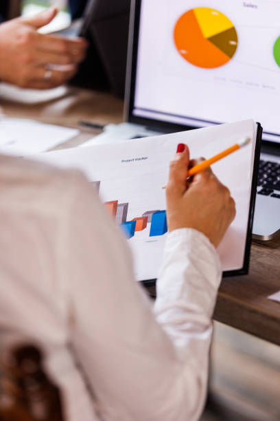 istock Businesswoman reviewing a clipboard with project result documents 1567169516