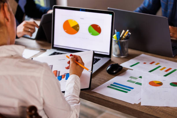 istock Businesswoman reviewing a clipboard with project result documents 1567169524