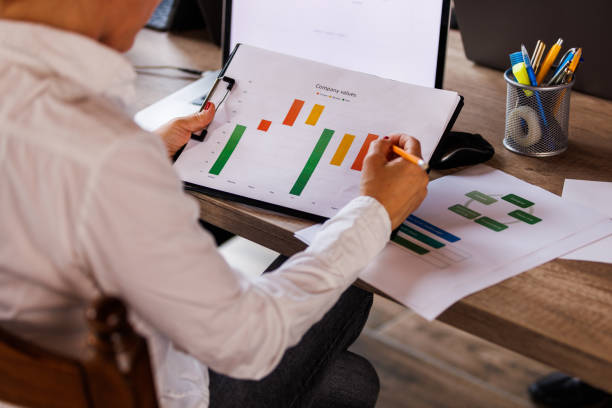 istock Businesswoman reviewing a clipboard with project result documents 1567169526