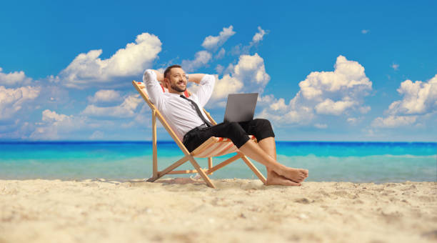 istock Businessman with a laptop enjoying on a holiday 1567170621