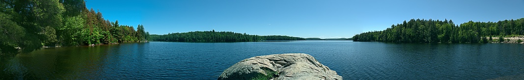 Algonquin Provincial Park Panoramic of lake, distance shore, sky and a boulder