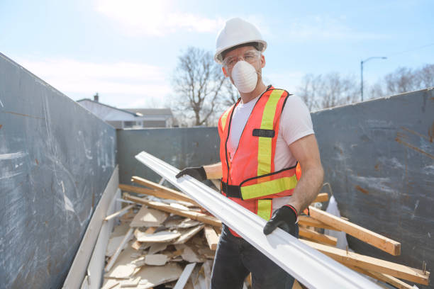 istock Construction Worker outside of house put old renovation material on big conteiner 1567176292