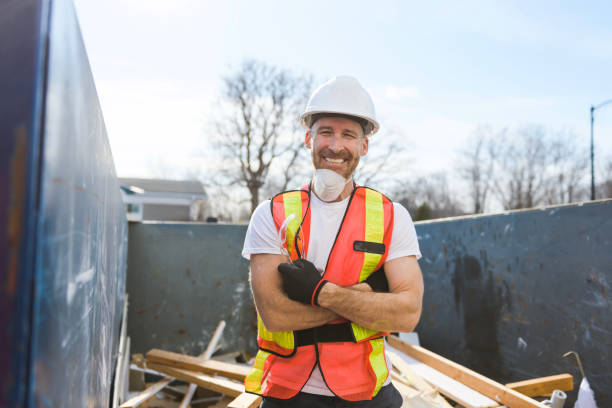 istock Construction Worker outside of house put old renovation material on big conteiner 1567176302