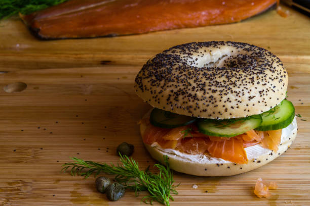 istock Seeded bagel with smoked salmon, cream cheese, cucumber, dill and capers, copyspace. 1567176308