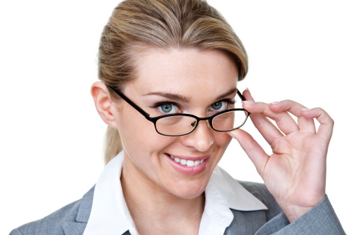 Cute businesswomen looking over the top of her eye glasses and smiling also isolated one white background 