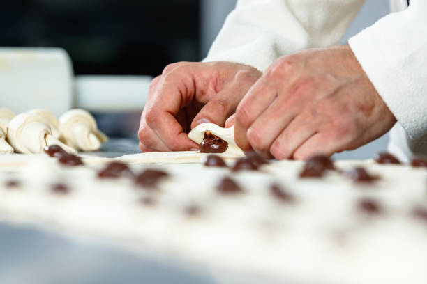 istock Chef making crescent rolls with chocolate filling on kitchen counter in small business 1567185741