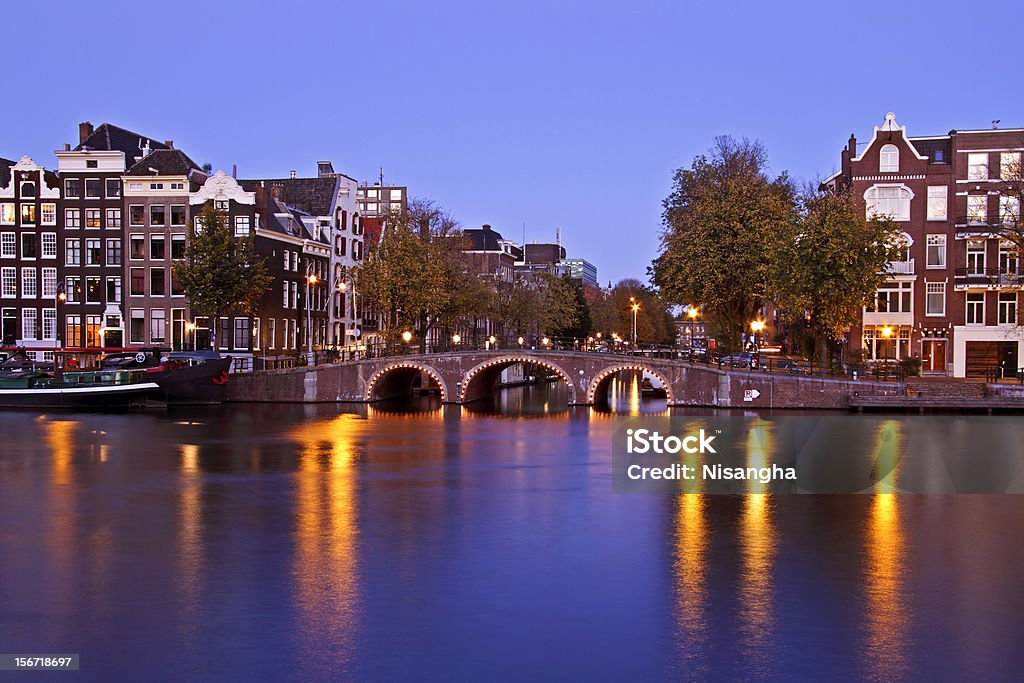 City scenic from Amsterdam Netherlands at twilight Amstel River Stock Photo