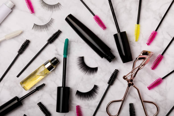 istock Composition with false eyelashes, mascara and eyelash brushes, eyelash curlers on a colored background. Makeup artist tools. Beauty concept. Makeup. Place for text. Place for copying. Flatley. MOCAP. 1567188008