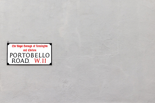 Portobello Road street sign on grey wall, with space for your text. Notting Hill, London, UK.