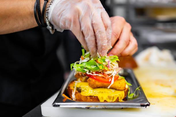 istock chef hand cooking burger with vegetables and meat on restaurant kitchen 1567208649