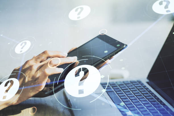 istock Creative abstract question mark sketch and hand working with a digital tablet on background, FAQ and research concept. Double exposure 1567219532