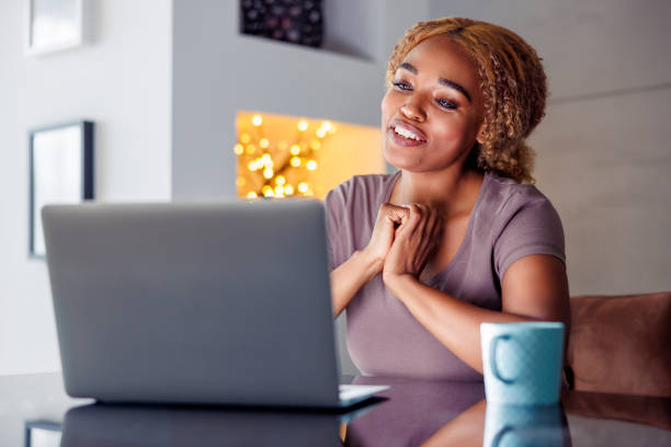 istock Woman drinking coffee and having video call using laptop computer 1567219761