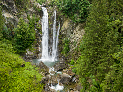 Cascata di Valclava or Kalmtaler Wasserfall waterfall in South Tirol, Italy during a beautiful springtime day in the Alps. The river Kalmbach is falling down in the midst of a dense forest