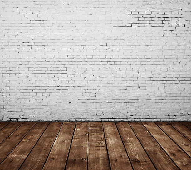 istock Worn white brick wall with wooden floor 156722796