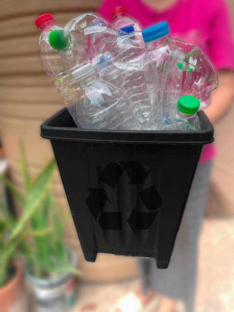 istock Asian old woman throwing bottles into the trash, recycling bin, sorting and throwing things in appropriate trash 1567241279