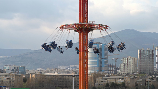 People swing ride at an amusement park in the capital of Iran, Tehran