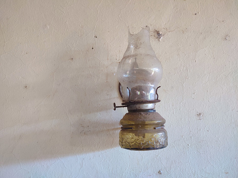 Old oil lamp hanging on the wall