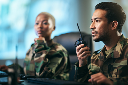 Walkie talkie, army and military team at the station with computer giving directions. Technology, collaboration and soldiers in control room or subdivision with radio devices for war contact.