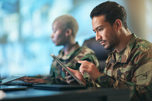 Asian man, army and tablet in research for military equipment, browsing or checking data at base. Male person, security or soldier working on technology for online search or networking at workplace
