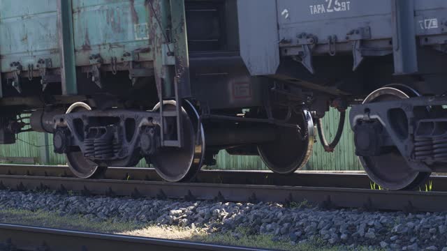 Freight train rides on the railroad. Close-up of the wheels
