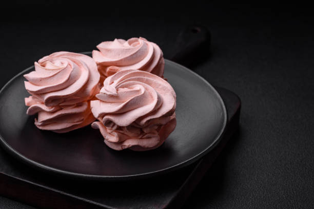 istock Delicious sweet colored marshmallow on a dark concrete background 1567257026