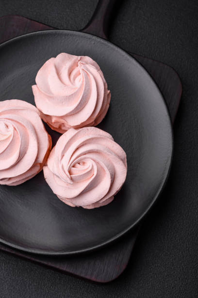 istock Delicious sweet colored marshmallow on a dark concrete background 1567257027