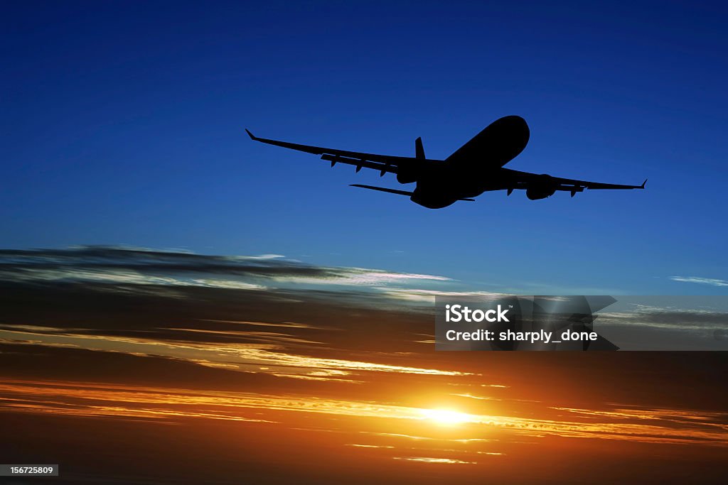XXL jet airplane taking off jet airplane in silhouette taking off at sunset (XXL) Taking Off - Activity Stock Photo