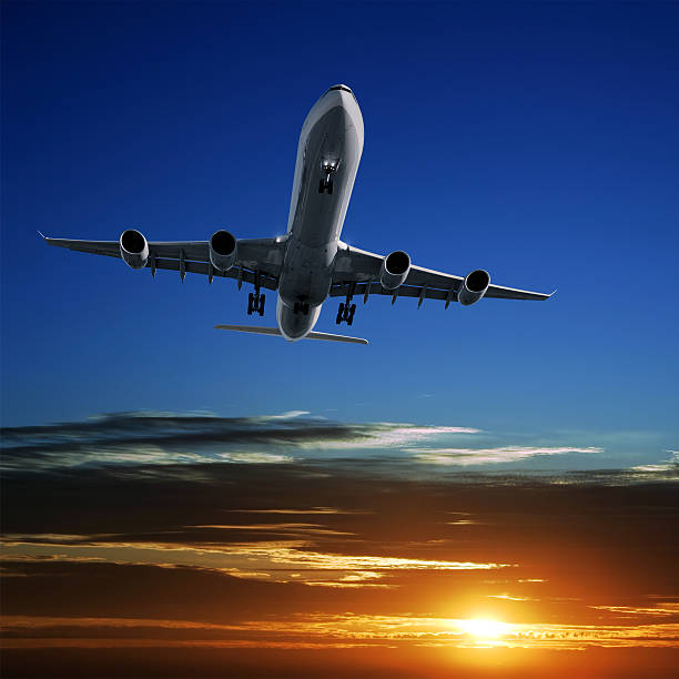 istock XL jet airplane landing at sunset 156725816