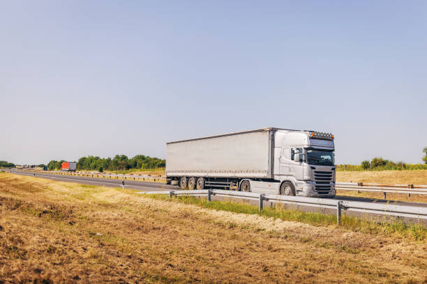 istock Cars and trucks on highway 1567283952