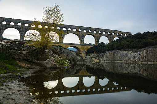 The Pont du Gard is an ancient Roman aqueduct in France. It was built around the 1st century AD to supply water to the city of Nîmes. It has three tiers of arches and stands about 50 meters high. The aqueduct bridge is a remarkable engineering marvel and is now a UNESCO World Heritage site.