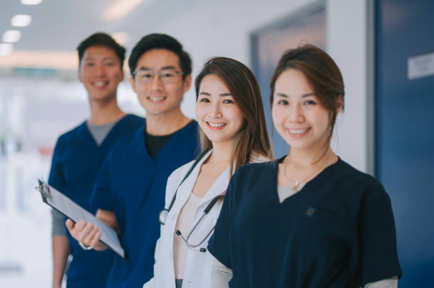portrait asian chinese doctors nurses in a row portrait asian chinese doctors nurses in a row nursing stock pictures, royalty-free photos & images